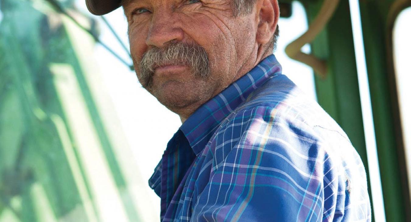 Farmer inside cab of tractor